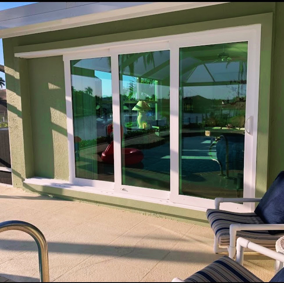 Impact sliding glass doors opening to a pool patio, Storm Pro door replacement in Sarasota County
