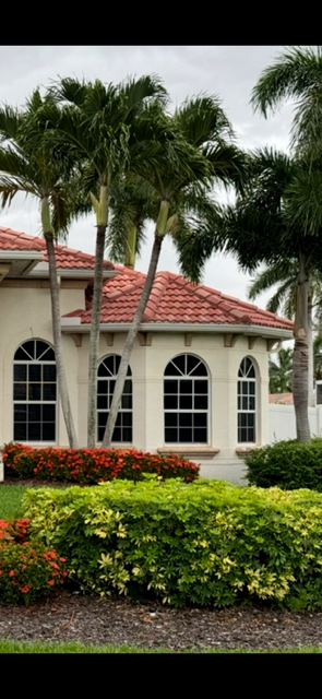 Tile-roof home with new arched impact windows