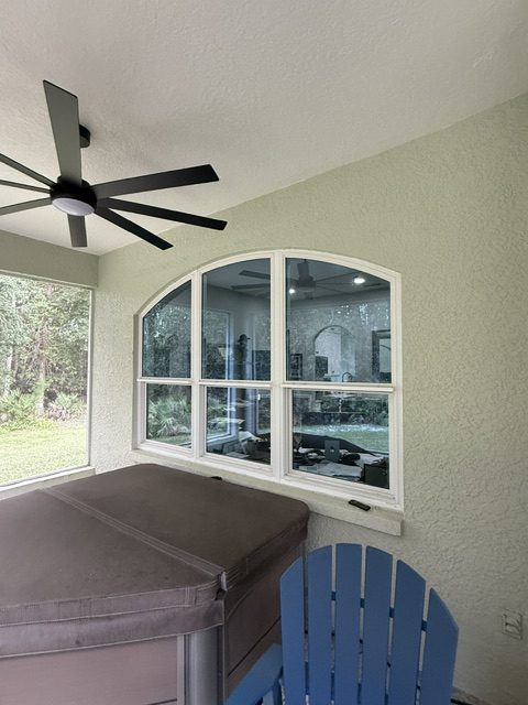 Custom hurricane impact windows: arched impact windows in a screened lanai