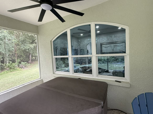 Grid impact windows with an arched top inside a Florida room