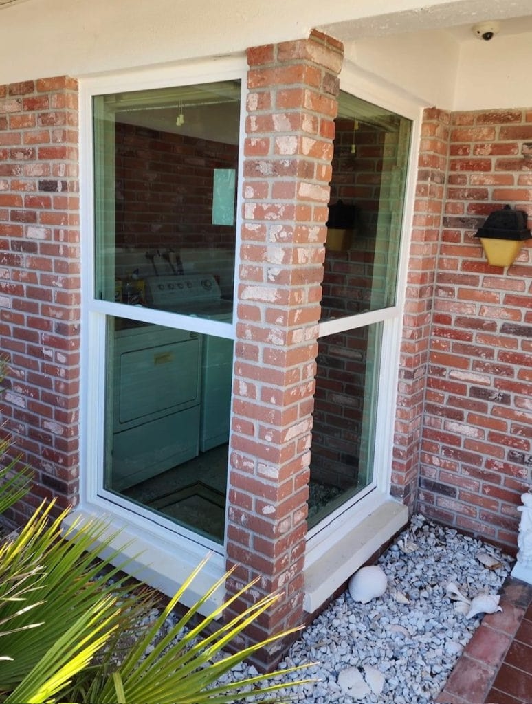 Tall impact windows on a brick home