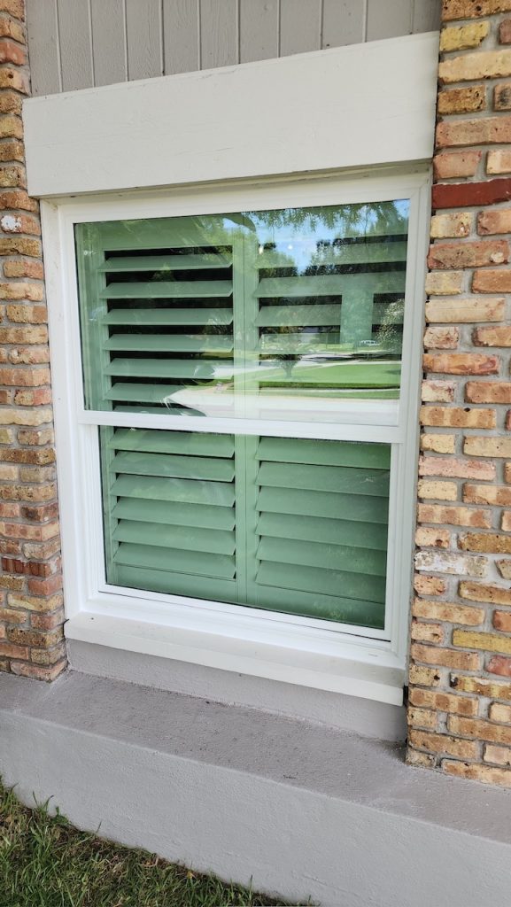 Single hung impact window on a brick home