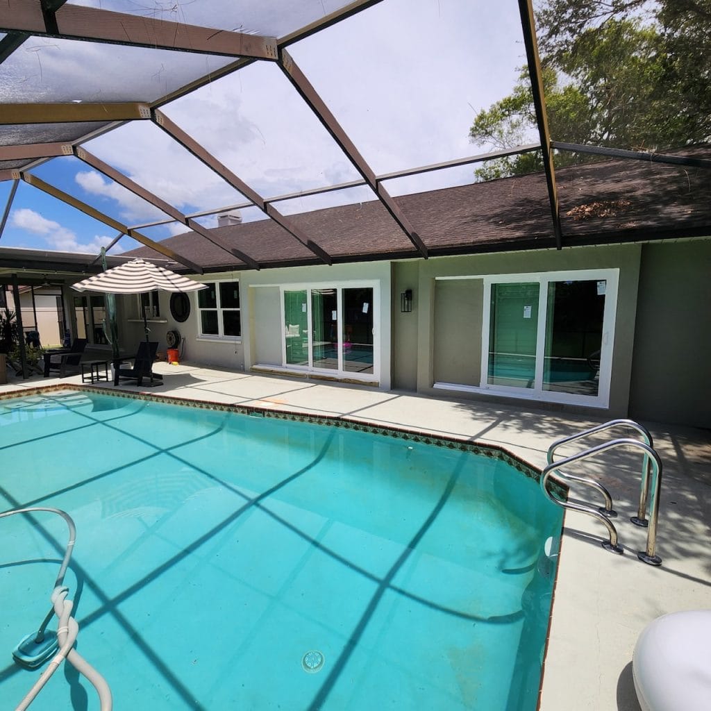 Impact sliding glass doors opening onto a screened pool, Storm Pro door replacement in Port Charlotte