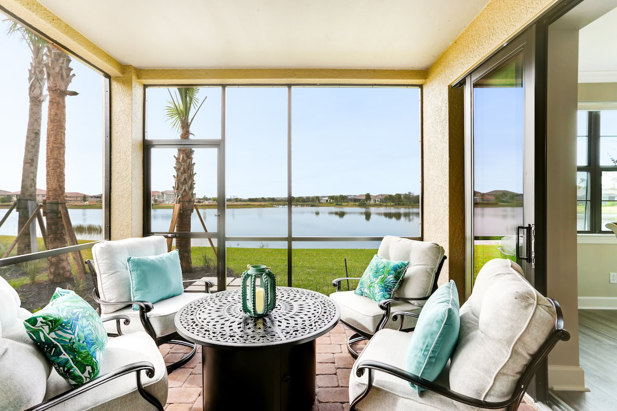 Florida lanai with floor-to-ceiling impact windows overlooking a lake