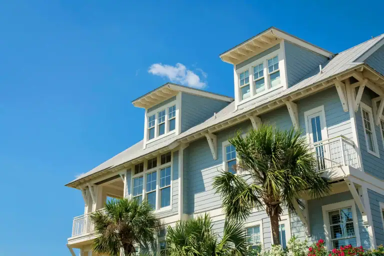 Blue coastal Florida home with impact-resistant windows