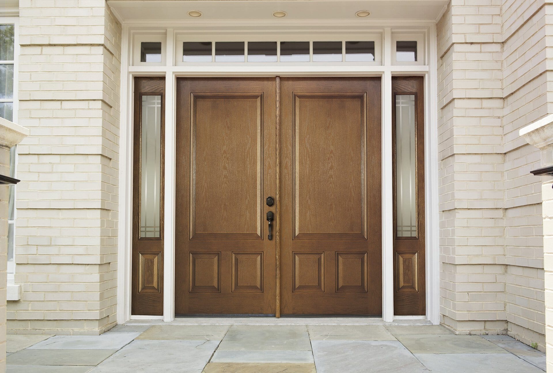 Stained wood-grain fiberglass double entry door with sidelites and transom