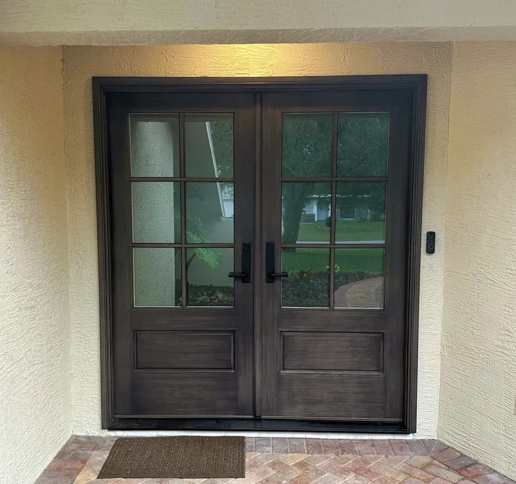 Dark double entry doors with divided glass panels