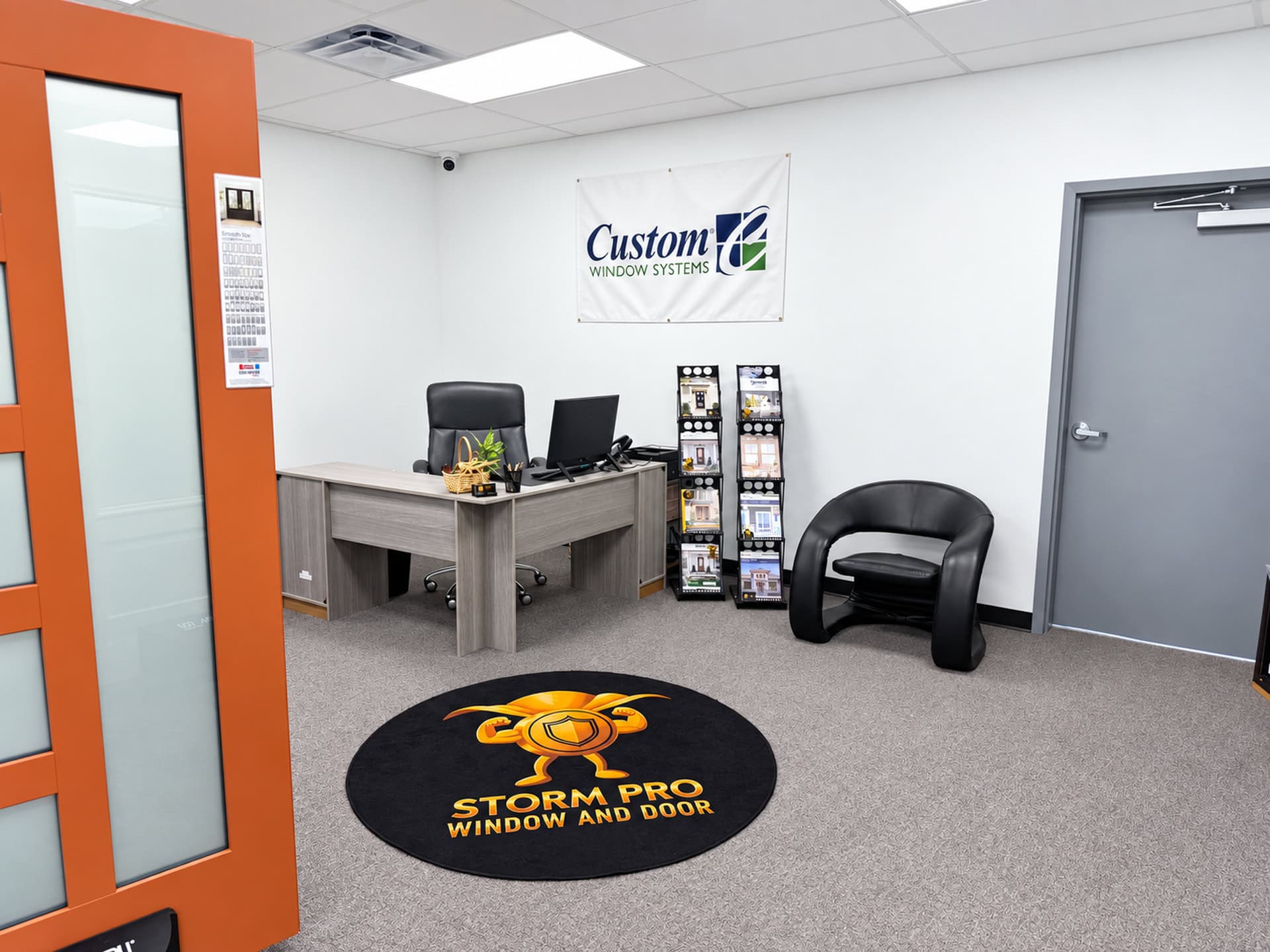 Storm Pro showroom reception area with a logo rug and window brochures