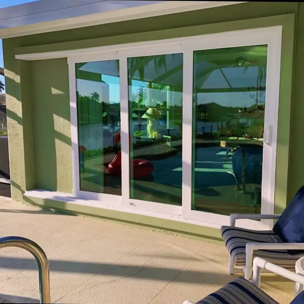 White-framed sliding glass doors opening onto a covered patio
