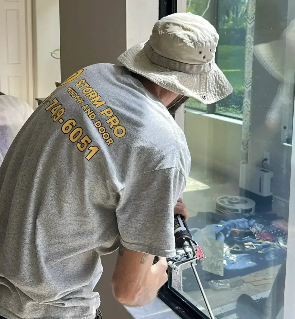 Storm Pro installer working at a window inside a home