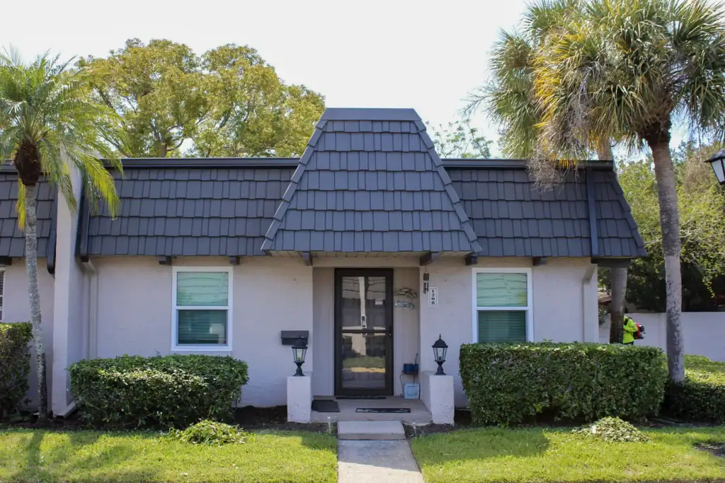 White-framed windows and entry door on a single-story stucco home
